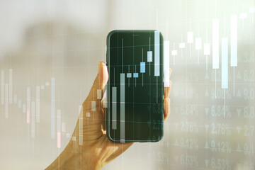 Abstract creative financial graph and hand with mobile phone on background, financial and trading...