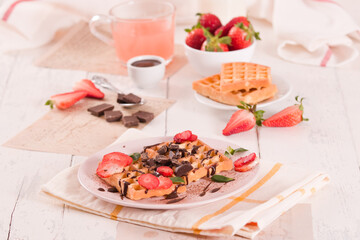 Waffles with strawberries and chocolate cream. - 607098484