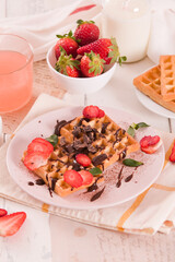 Waffles with strawberries and chocolate cream. - 607098499