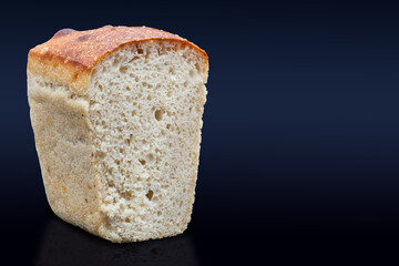 Rye bread on a dark background in the cut with a crispy crust and texture in the hole. Fresh home baked sourdough bread. Photo in high quality