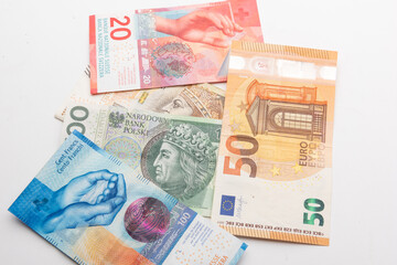 polish zloty, swiss francs and euro currency coins and banknotes
