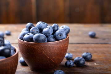 Freshly picked blueberries in  bowl. Bilberry on wooden Background. Blueberry antioxidant. Concept for healthy eating and nutrition