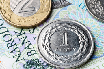 polish zloty currency coins on banknote close-up