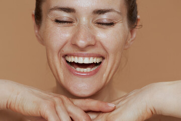 smiling woman with wet face washing - Powered by Adobe