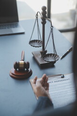 Justice and law concept.Male judge in a courtroom with the gavel, working with, computer and...
