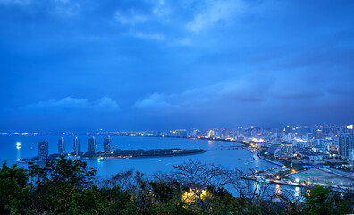 Obraz na płótnie Canvas Bird's-eye view of the coastal city, Sanya, Hainan, China at night.
