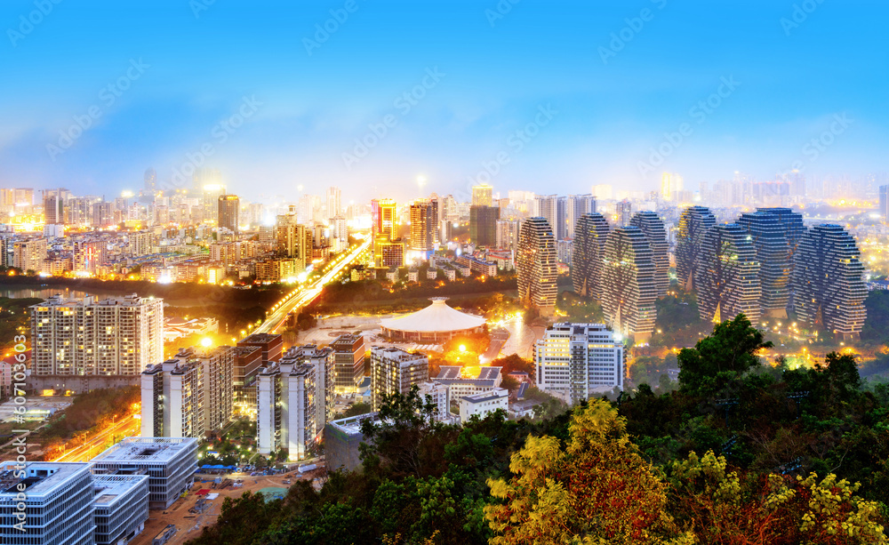 Wall mural Bird's-eye view of the coastal city, Sanya, Hainan, China at night.