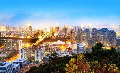 Fototapeta premium Bird's-eye view of the coastal city, Sanya, Hainan, China at night.