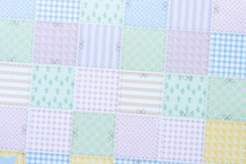 scrapbook paper composed of many squares each with particular pattern