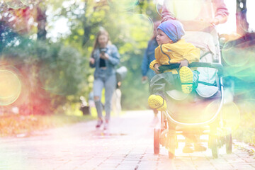 autumn walk child in a stroller, street outdoor city landscape