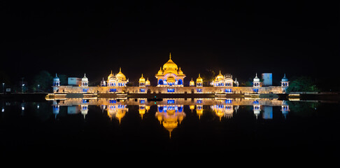 multi-photo panorama, night view, sacred place kusum sarovar on govardhan hill, temple in india, place of pilgrimage