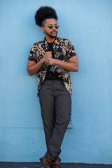 Portrait of stylish man seen standing against wall