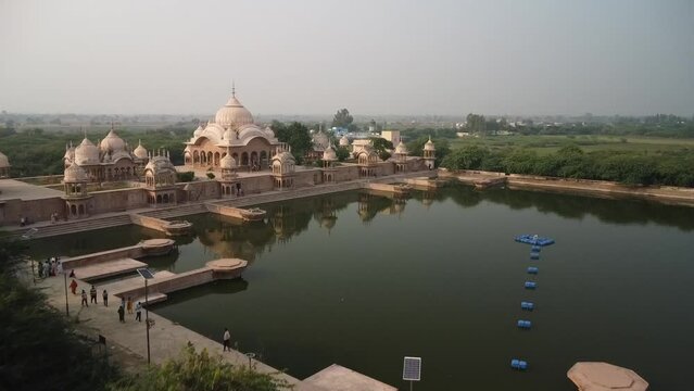 drone filming at sunset, sacred place kusum sarovar on govardhan hill, temple in india, place of pilgrimage