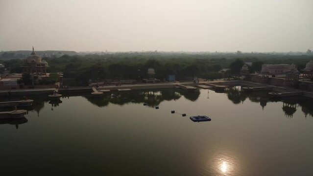drone filming at sunset, sacred place kusum sarovar on govardhan hill, temple in india, place of pilgrimage