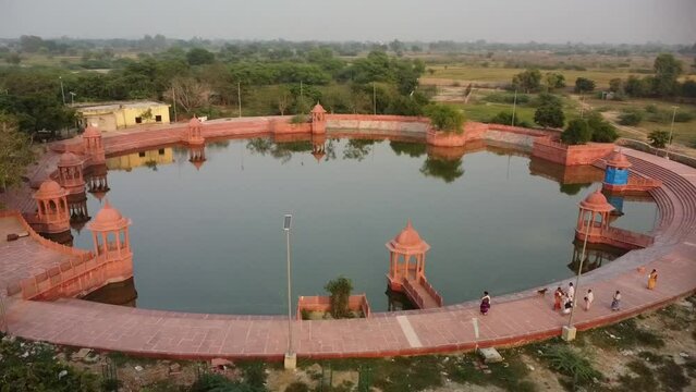 drone filming at sunset, narada kunda lake, sacred place on govardhan hill in india, place of pilgrimage, shrine of believers
