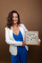 Smiling coaching woman showing a notice board. Democratic and motivating management.