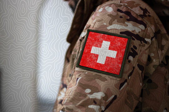 Switzerland Soldier. Soldier with flag Switzerland, Switzerland flag on a military uniform. Camouflage clothing