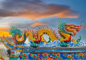 Colourful multicoloured dragon on top of a  temple in Patong Phuket Thailand. beautiful blue green red of the scale dragons