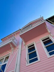 Fototapeta na wymiar facade of a pink wooden cottage
