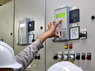 The electrical engineer rechecks the protection relay setting with a witness.