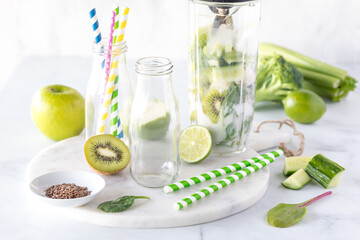 A blender container filled with ingredients to make a healthy green smoothie.
