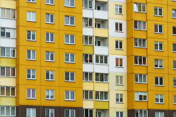 Modern residential multi-storey building. Windows and balconies on a new residential building close-up. Buying and selling apartments, rental housing, happy family life in a comfortable apartment.