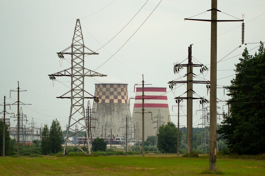 Industrial landscape with transmission towers and factory chimneys