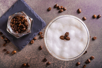 Close up of cold martini espresso cocktail in glasses and coffee beans on the table top view