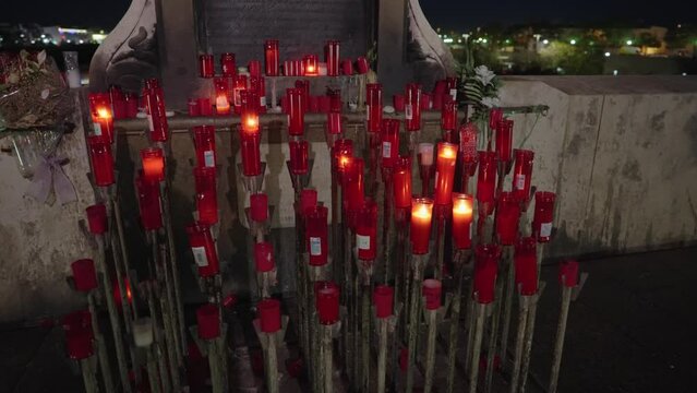 Statue of the Archangel Raphael stands in the middle the ancient Roman bridge, looking out across the river towards the old city of Cordoba, Spain