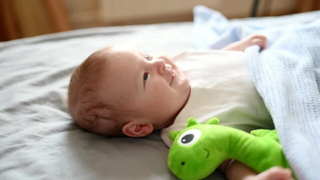 Cute baby lies in the crib sleeps at home with his favorite toy.Childhood protection concept, children day, sleep toy