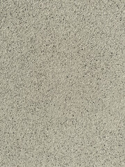 Textured plaster, white with black in the form of small stones, used as a background, side view, texture