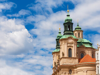 Fototapeta na wymiar Baroque art and architecture in Prague. Church of Saint Nicholas beautiful dome and twin bell towers erected in 18th centuty in Stare Mesto (Old Town) district