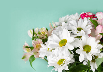 bouquet of garden flowers on a green background, copy space