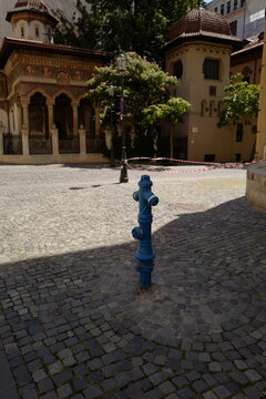blue fire hidrant in front of ancient church building