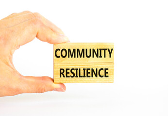 Community resilience symbol. Concept word Community resilience typed on wooden blocks. Beautiful white table white background. Businessman hand. Business and community resilience concept. Copy space.
