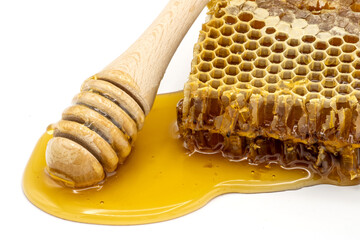 Close up of honeycomb with honey and honey dipper