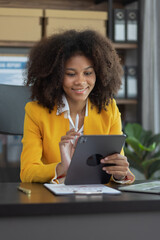 African American businesswoman using digital tablet at office workplace.