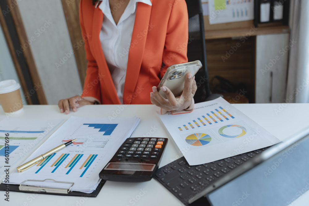 Poster hands of accountant using calculator and smartphone with chart at office on his desk, business accou
