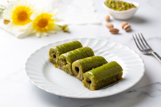 Pistachio baklava. Traditional Middle Eastern Flavors. The local name of Baklava is Fıstıklı Baklava or fıstıklı dolama. Turkish style pistachio baklava presentation and service