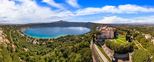 Foto auf Glas  Most scenic lakes of Italy - volcanic Albano lake , aerial drone view of Castel Gandolfo village and crater of volcno. popular touristic site near Romem, famous as Pope residense © Freesurf