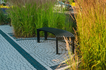 Black Iron Arch-Shaped Bench in the Park: Close-Up View