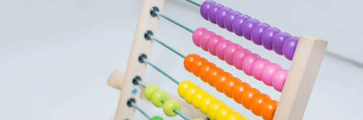 Preschooler learns to count. abacus toy.child having fun indoors at home, kindergarten or day care...