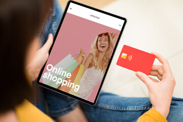 Young lady look at fashion store at tablet screen, use credit card for buy new clothes with app banking
