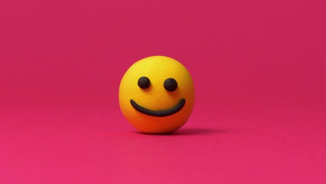 Happy smiley emoticon on red background
