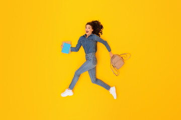 Fototapeta na wymiar Lady Student With Backpack And Books Running Over Yellow Background