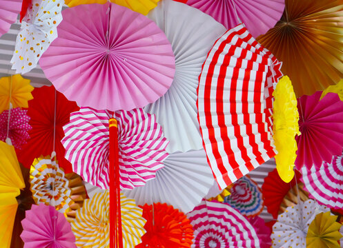 Multi-colored paper Chinese fans, pink, white, yellow, fan circles for the holiday, the new year