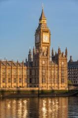 Naklejka premium Early sunny morning with Palace of Westminster and Big Ben clock tower seen across River Thames, London, United Kingdom