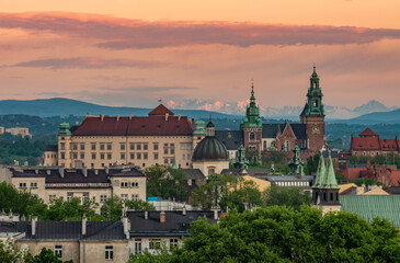 Fototapeta premium Wawel castle during colorful sunset with snowy Tatra mountains in the background, Krakow, Poland