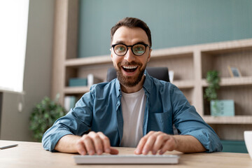 Pov Shot Of Excited Young Businessman Using Computer At Office