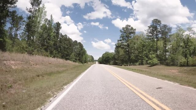 Rear POV FPV driving on a rural country curved road